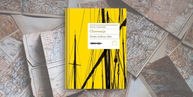 Yellow book laid on various maps.