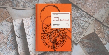 Orange book laid on various maps.