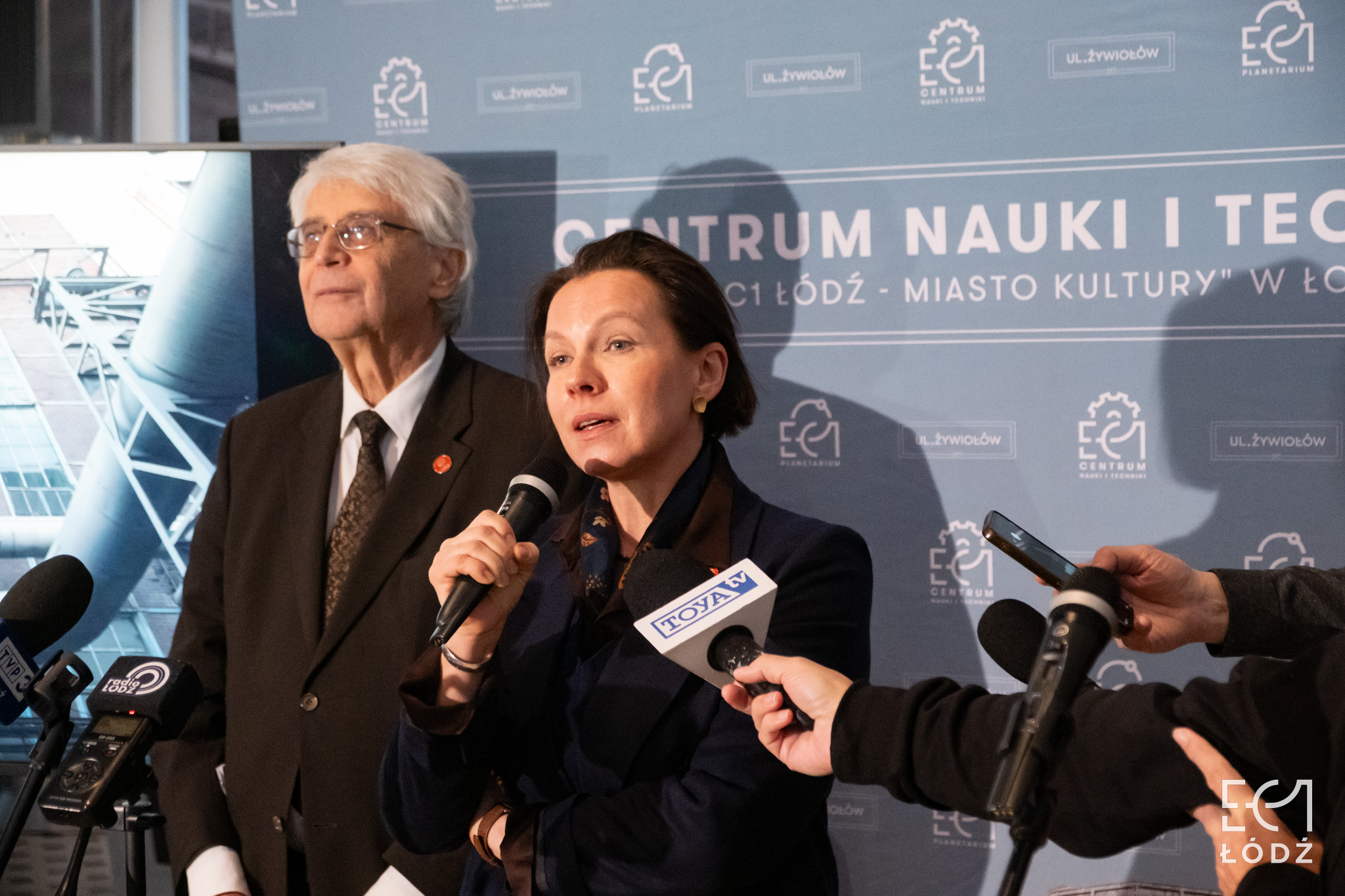 Agata Wąsowska-Pawlik wypowiada się do mikrofonu. Obok niej stoi prof. Jacek Purchla.