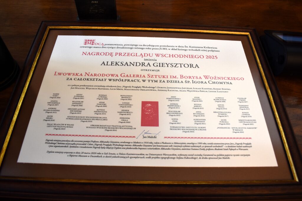 Framed diploma of the 2025 Przegląd Wschodni Award named after Aleksander Gieysztor for the Lviv National Art Gallery named after Borys Voznytskyi, photographed on a wooden table.