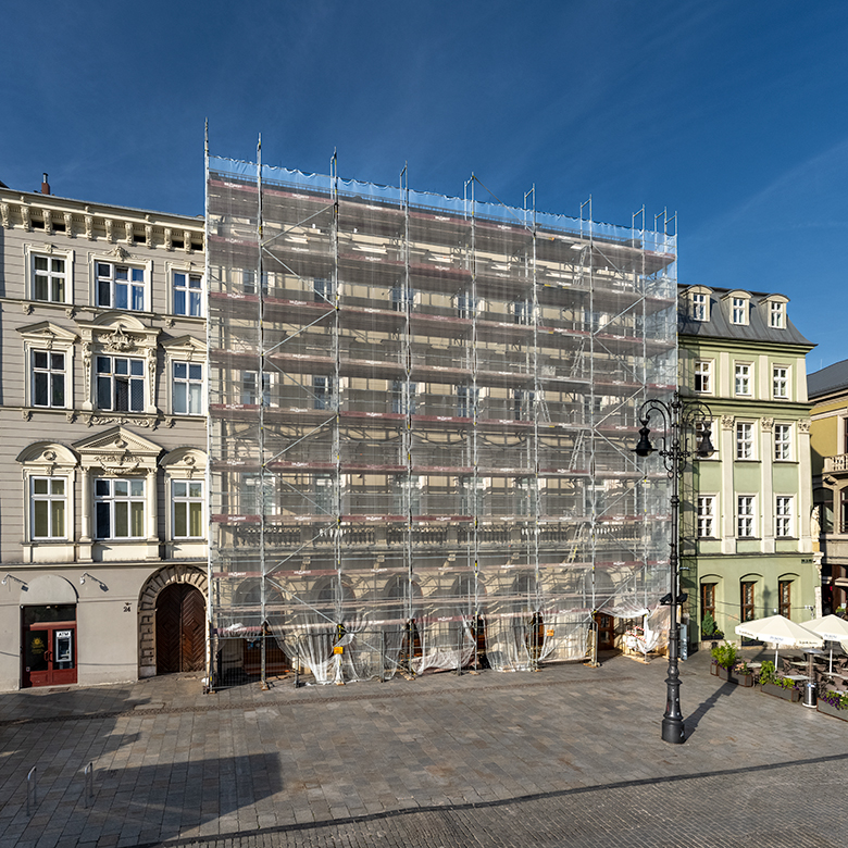 Pod Kruki townhouse covered with scaffolding during renovation.